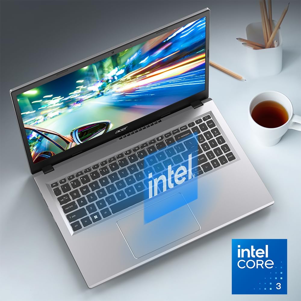 Laptop with Intel logo on a desk with a cup of tea and pencils