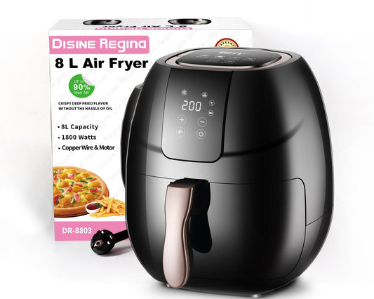 Black air fryer with digital display next to its packaging on a white background