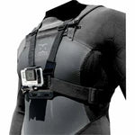 Black camera harness with a GoPro attached on a person, against a black background