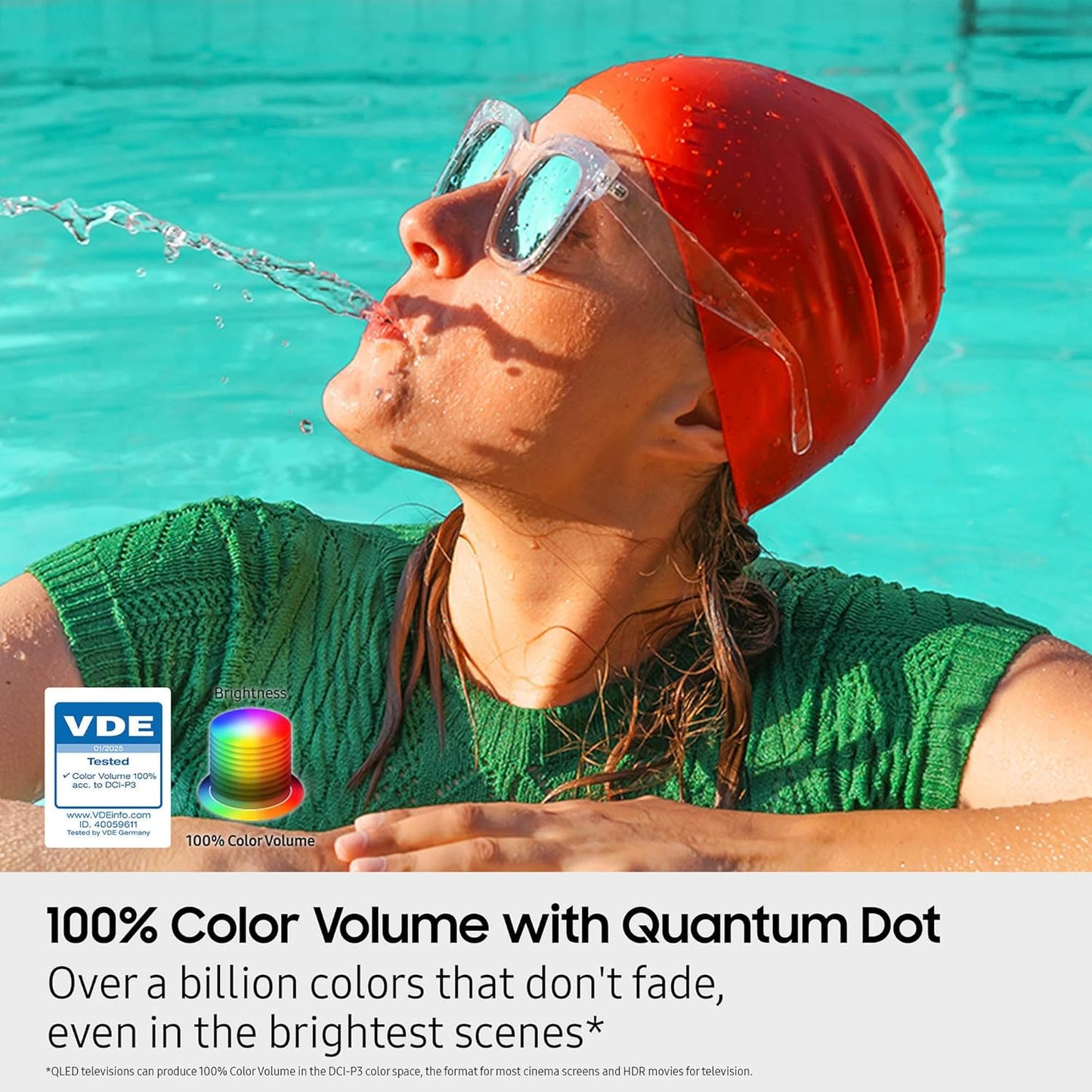 Person wearing a swim cap and goggles, splashing water, with promotional text about 100% color volume with Quantum Dot technology.