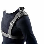Person wearing a black shirt with a gray shoulder harness.