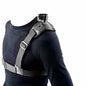 Person wearing a black shirt with a gray shoulder harness.