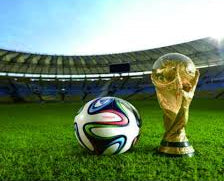 World Cup trophy and soccer ball on grass in front of a stadium